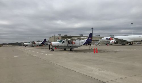 The image is of FedEx planes parked at the airport.